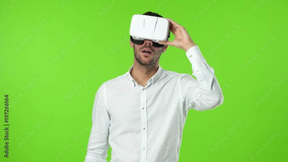 Astonished young man using a virtual glasses