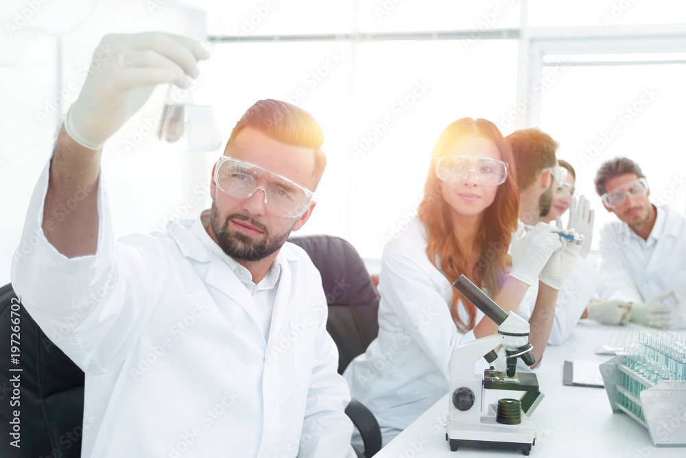 biochemist with flask Petri sitting at a Desk biochemist with flask Petri sitting at a Desk