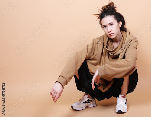 Fashion Model, Fashion, Teenage Girls. Posing over beige background