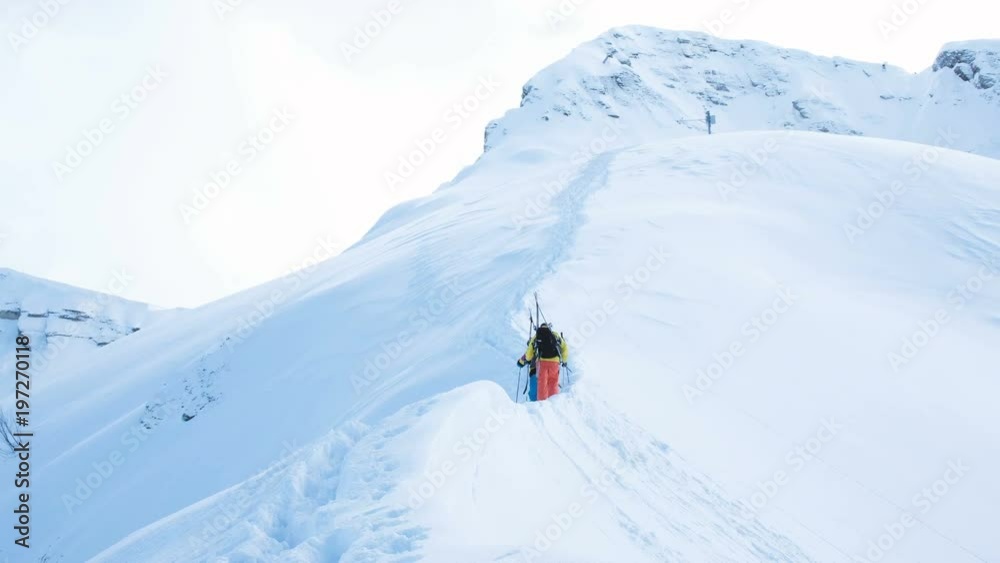 Skiers climb to the top of the mountain for freeride Skiers climb to the top of the mountain for freeride