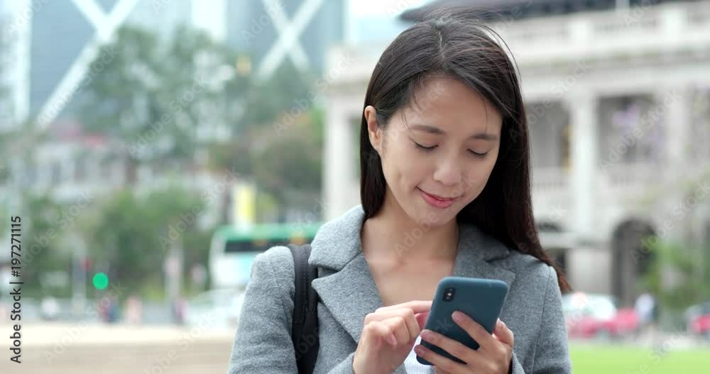 Asian Woman use of cellphone in city Asian Woman use of cellphone in city