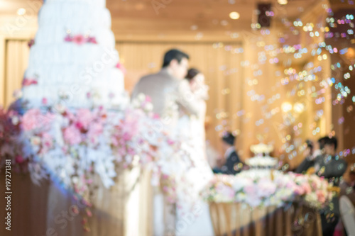 Abstract blurred soft of couple wedding cake and bubbles in the wedding banquet.