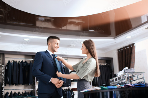 Female shop assistant helpi...