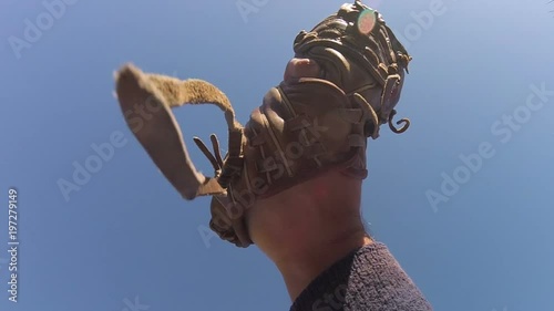 Baseball player catching flyball in slow motion