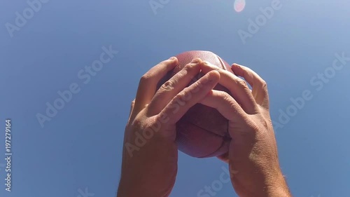 Slo-mo of a football being caught by receiver