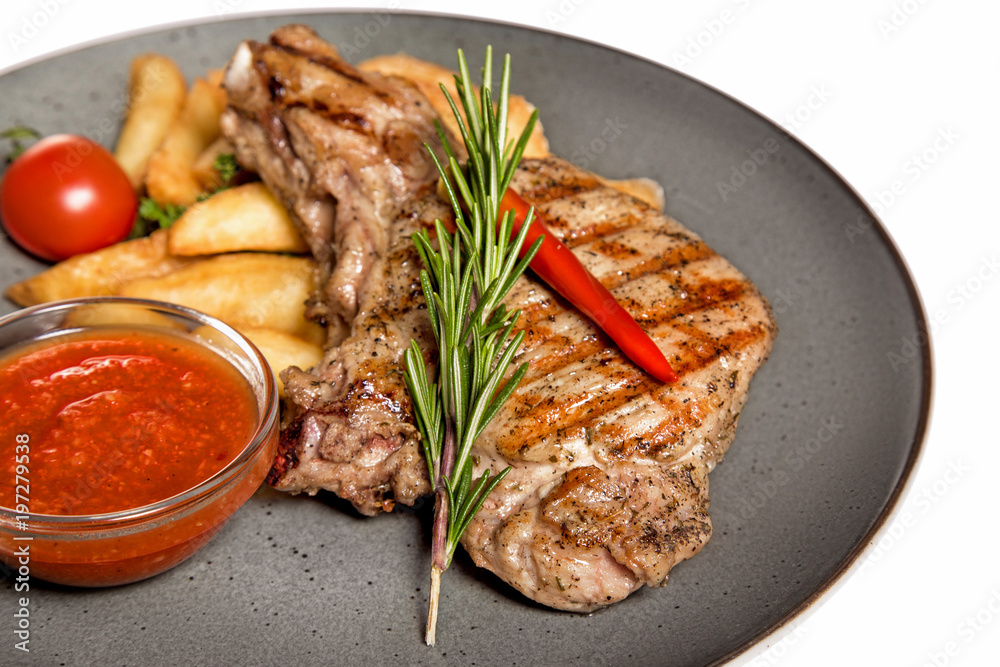fried meat with garnish of potatoes isolated on white background fried meat with garnish of potatoes isolated on white background