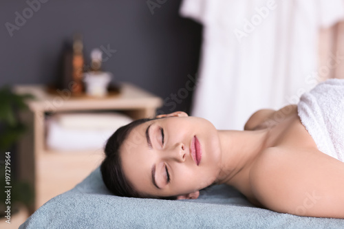 Young beautiful woman relaxing in spa salon