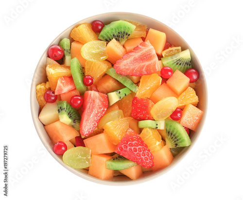 Bowl with fresh cut fruits on white background