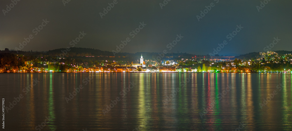 panorama of a city at lake constance during nighttime