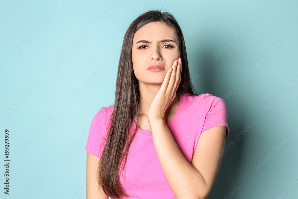 Young woman with sensitive teeth on color background Young woman with sensitive teeth on color background