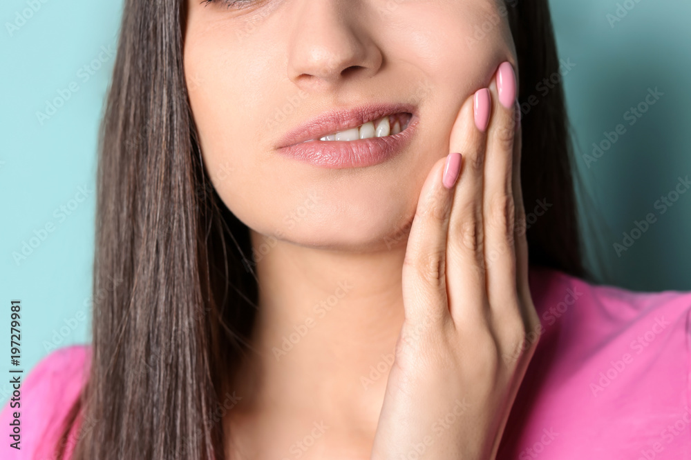 Young woman with sensitive teeth on color background, closeup Young woman with sensitive teeth on color background, closeup