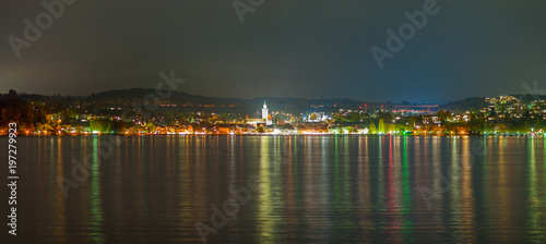 panorama of a city at lake constance during nighttime © C@rsten