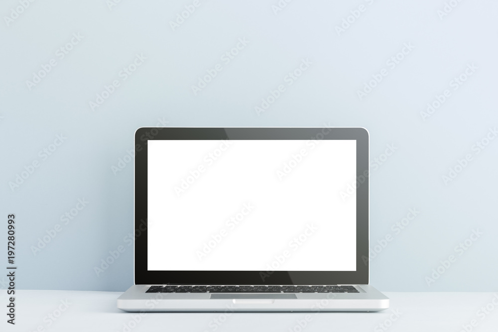 Table with laptop on a bright blue background. Mock up. Table with laptop on a bright blue background. Mock up.
