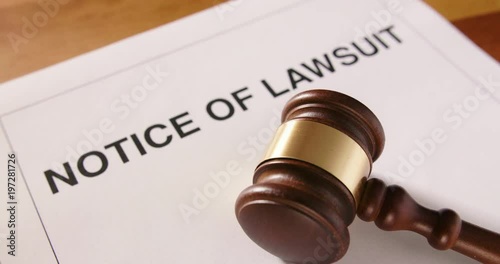 Dolly Shot Of Gavel Over Notice Of Lawsuit Text 4K