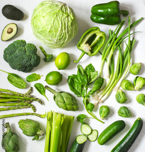 Green vegetables and fruits on a white background. Fresh organic produce. Healthy food.