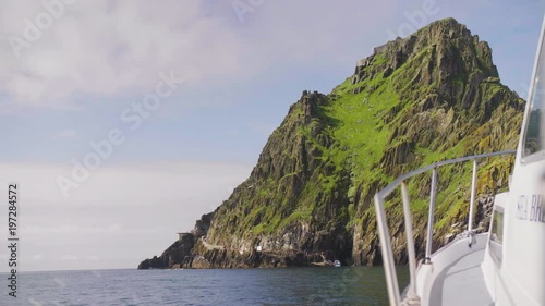 Boat Moving Towards Skellig Michael Island Against Sky photo