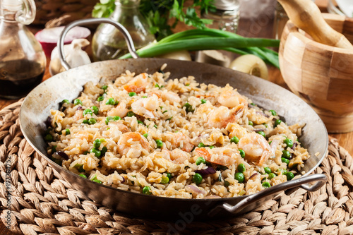 Fried rice with shrimp and vegetables on a frying pan