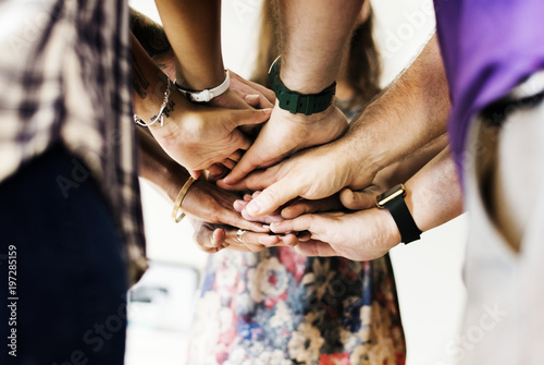 Group of diverse people joining hands together