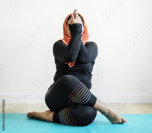 Islamic woman doing yoga in the room