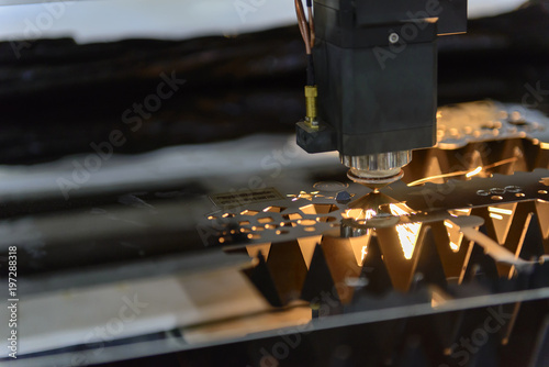 Close-up of the laser cutting machine cutting the stainless plate.