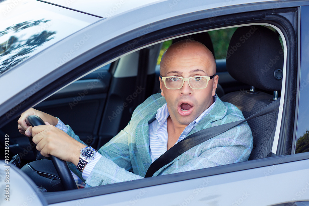 Man driving a car shocked about to have traffic accident, windsh