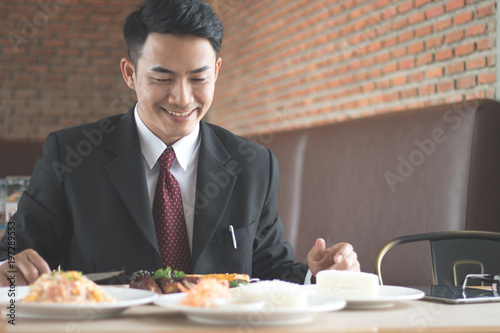 Businessman holding fork and knife eating steak  business and food restaurant concept