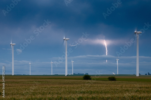 Wind turbines with a lightning bolt on the background