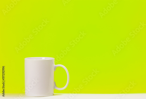 Cup white coffee on colored background with space for text