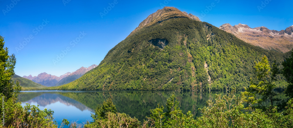 Beautiful reflections at Lake Gunn on the way to Milford Sound in New Zealand.