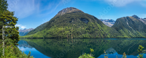 Lake Gunn Panorama with Reflections in Water on the road to Milford Sound in Fiordland National Park, New Zealand.