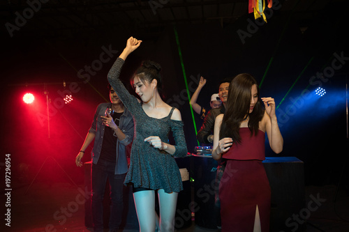 Party young people group dancing in night club