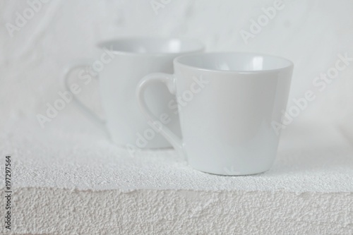 tableware mockup. Minimalist cup Mockup. white cups on a white  relief background. White cup on white background. copy space
