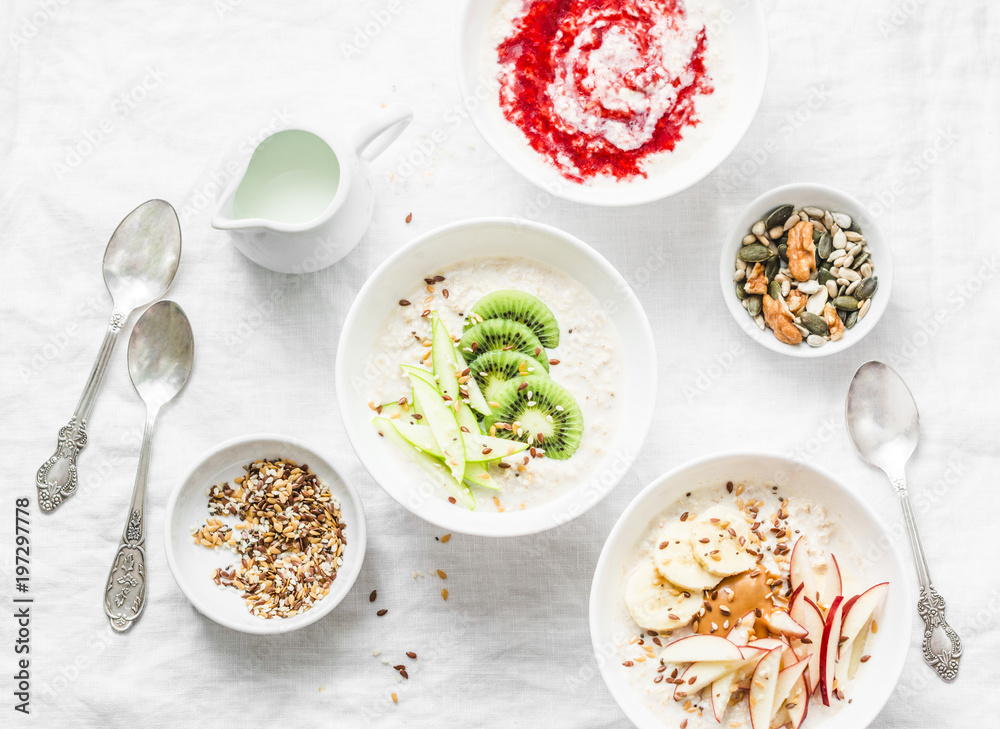 Morning breakfast inspiration - coconut overnight oatmeal with various topping. Healthy gluten free food concept. Top view, flat lay Morning breakfast inspiration - coconut overnight oatmeal with various topping. Healthy gluten free food concept. Top view, flat lay