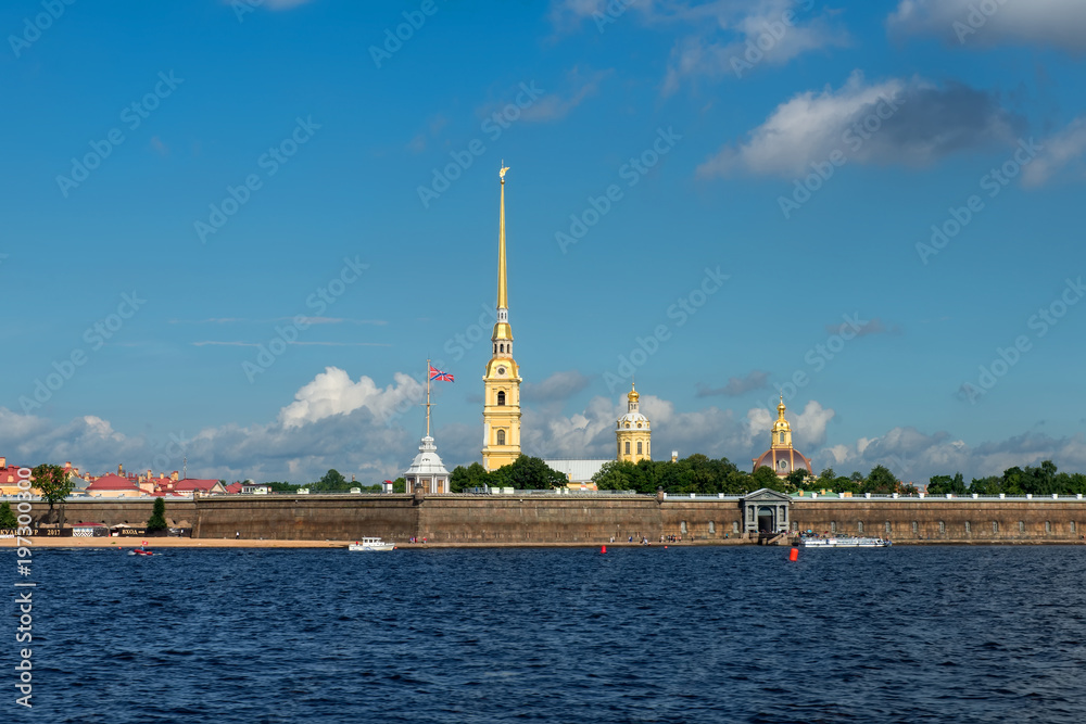 RUSSIA, SAINT PETERSBURG - AUGUST 18, 2017: View on the Peter and Paul Fortress, the river Neva, the steeple with a cross, dome, sky, warm summer day, storm sky