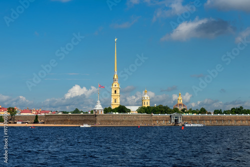 RUSSIA, SAINT PETERSBURG - AUGUST 18, 2017: View on the Peter and Paul Fortress, the river Neva, the steeple with a cross, dome, sky, warm summer day, storm sky