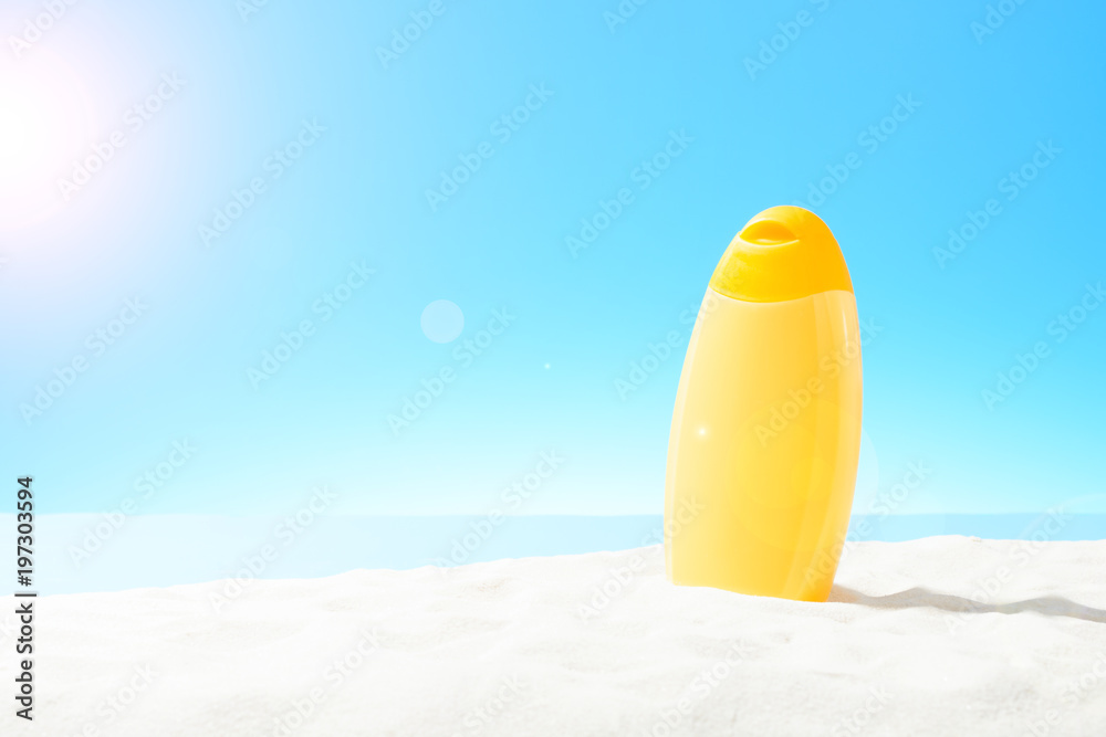 Orange bottle of sunscreen on a sandy beach Orange bottle of sunscreen on a sandy beach