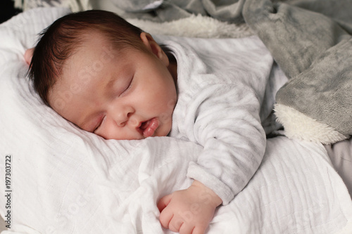 Beautiful baby girl sleeping on a bed 