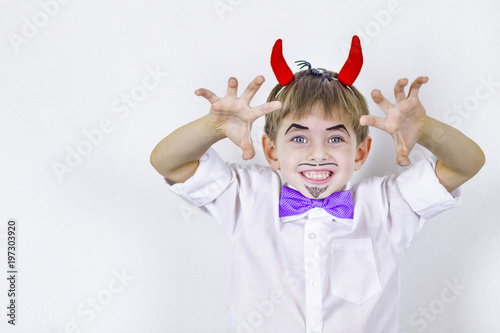 Cheerful Boy with red horns April fool's day.