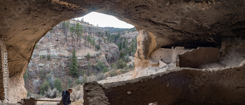 Man exploring cave dwelling  at Gila Cliff Dwellings National Monument, Silver City New Mexico