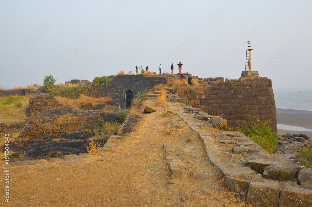 KOLABA FORT, MAHARASHTRA, INDIA 13 JAN 2018, Tourist standing on the bastion of Kolaba fort looking at the sea