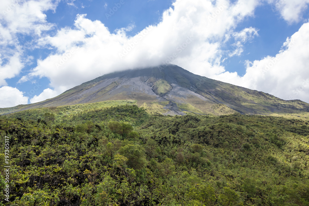 Arenal Volcano in Costa Rica with its peak shrouded in light clouds