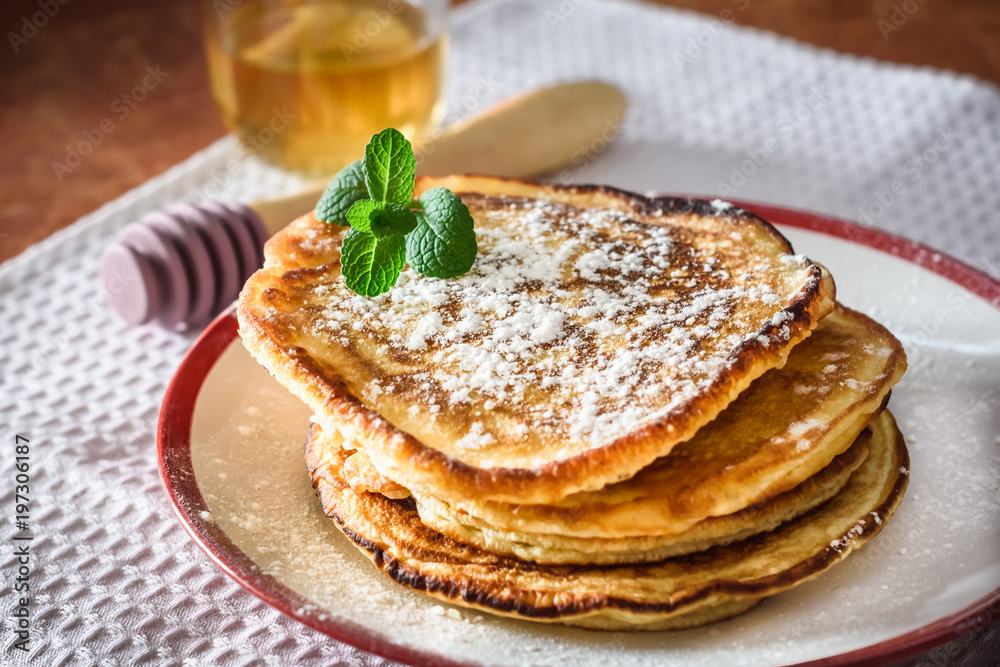 Pancakes with honey for breakfast on kitchen table Pancakes with honey for breakfast on kitchen table