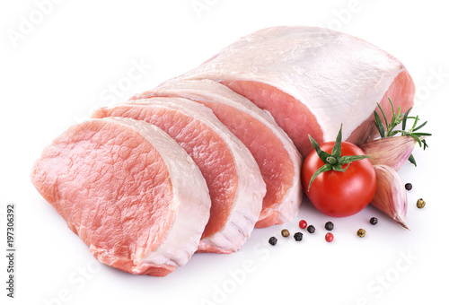 Raw sliced pork loin with tomato, pepper, rosemary and garlic isolated on white background. Fresh meat.