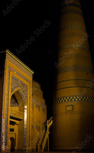Epic night view of Islom hoja (Islam Xoja) minaret in Itchan Kala (Ichon Qala). Ancient town on the silk road. Khiva, Xorazm Province, Uzbekistan. photo