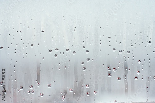 Water droplets condensation background of dew on glass window, humidity and foggy blank background. Outside the window, bad weather, rain photo