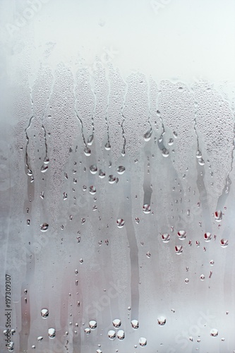 Water droplets condensation background of dew on glass window, humidity and foggy blank background. Outside the window, bad weather, rain