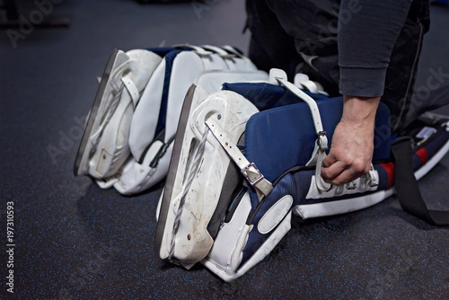 Hockey players are preparing to play in the locker room