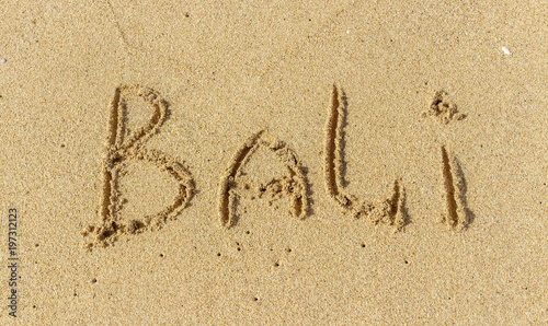 The inscription on the sand of Bali. Vacation time, beach holidays. © kordeo