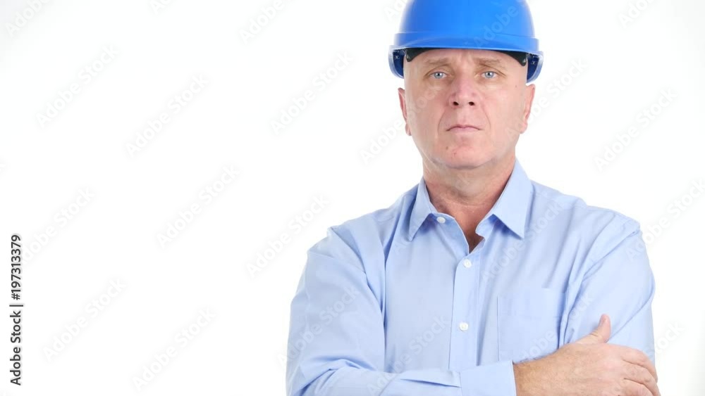 Serious Technical Businessperson Wearing Protection Hat Looking to Camera Serious Technical Businessperson Wearing Protection Hat Looking to Camera