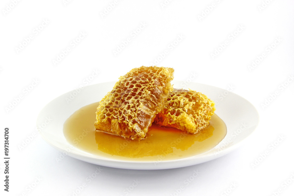 Fresh honey with honeycomb on a white background Fresh honey with honeycomb on a white background